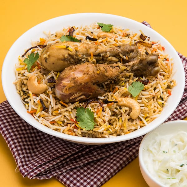 Chicken Biryani from Bombay Kitchen, with two chicken drumsticks, rice, cashews, and cilantro.